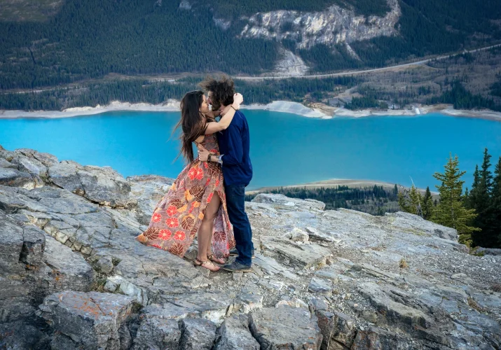 Couple share a kiss during their engagement session in the Canadian Rockies. Moment captured by the best Banff Wedding Photographer.