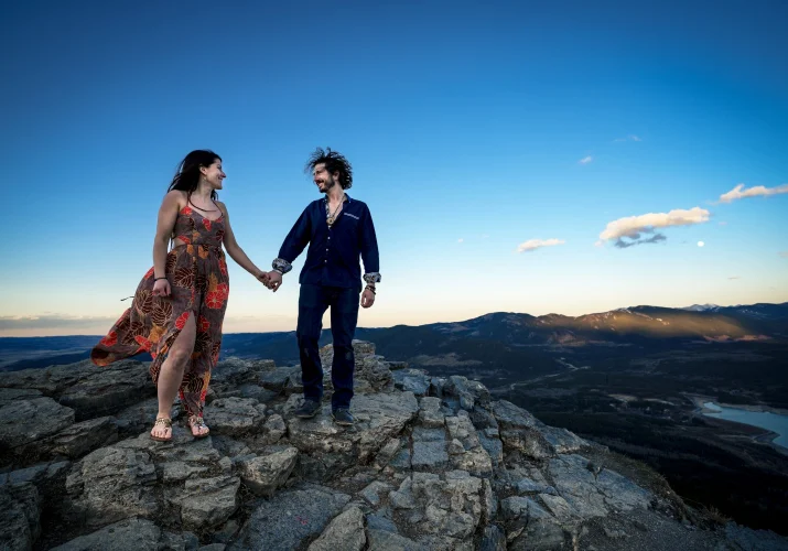 couple look at each other during their adventure session close to Banff.