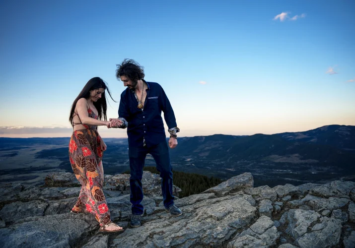 Gentleman helps his fiancée while hiking in Banff.