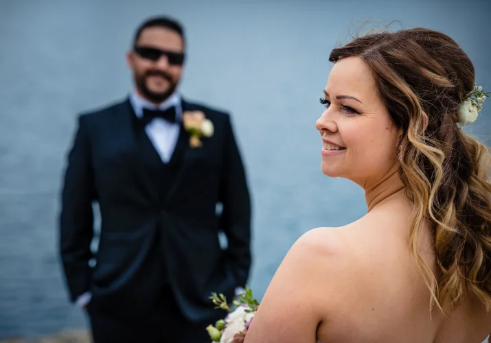 Groom adores the beauty of his wife. The bride looks on the right.