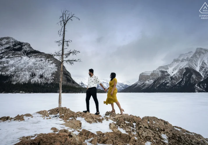 Engagement photo by the frozen Minnewanka Lake.