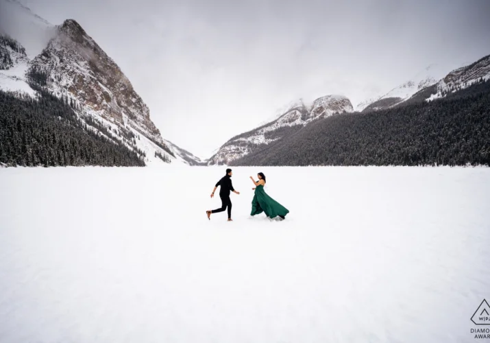 Engaged couple run into each other at the frozen Lake Louise.