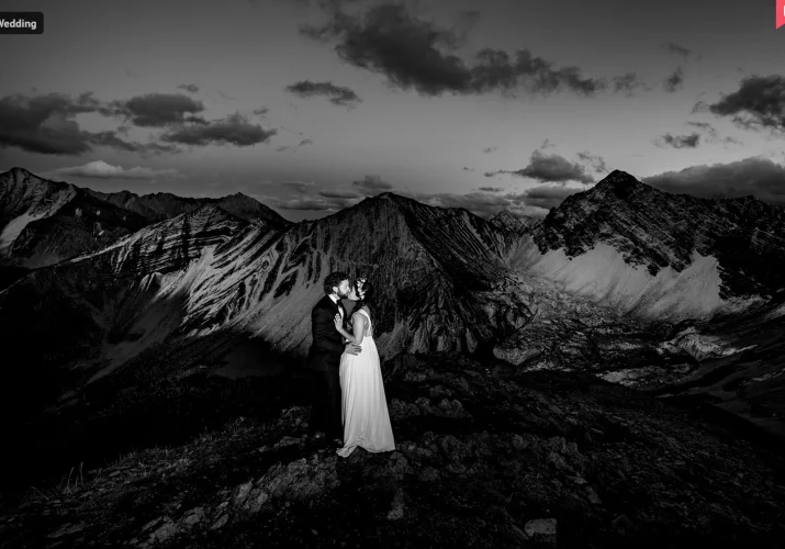 Newlyweds on the top on the mountain in Banff.