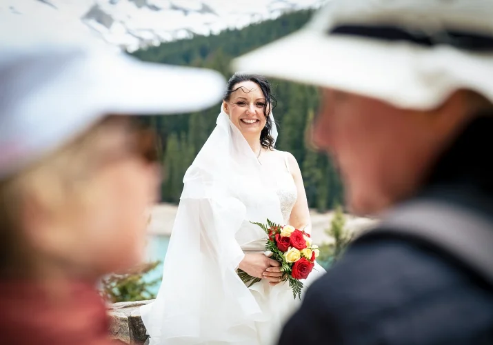 bride captured by shoot through the tourists at Moraine Lake