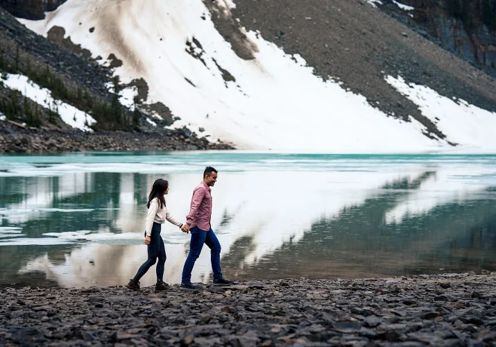 Engaged couple walk down the Moraine Lake.