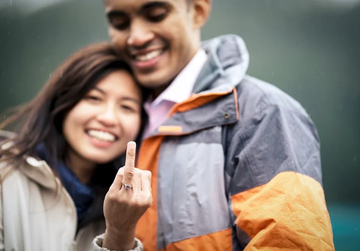 smiling couple in love. A girl shows her ginger with a brand new engagement ring
