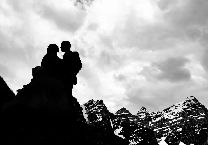 Newlyweds silhouette in the mountains in black and white taken by the best Calgary Wedding Photographer
