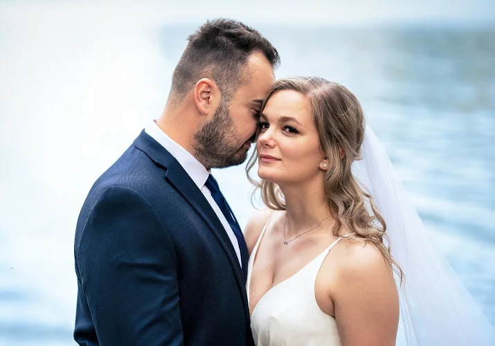 Groom touches the bride head with his nose. Romantic scene