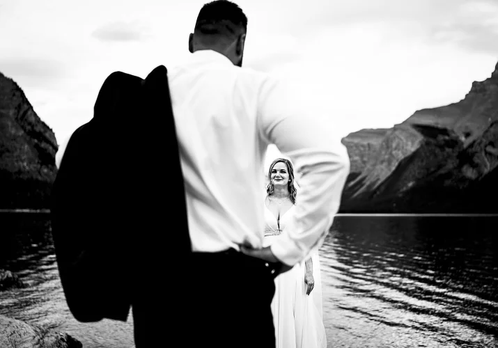 Photography through the grooms arm on beautiful bride