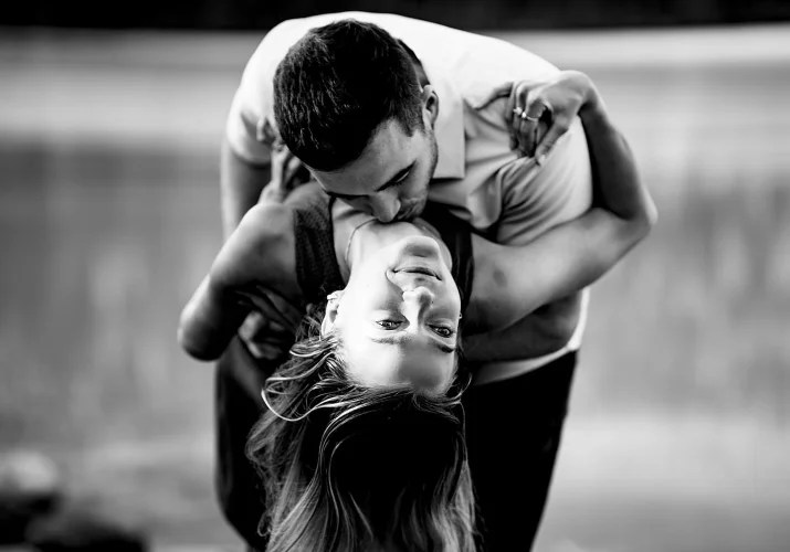 Man in love kisses his fiancee 's neck. Intimate Banff Wedding photograph yin black and white