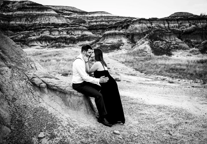 After-wedding photograph of kissing couple in black and white.