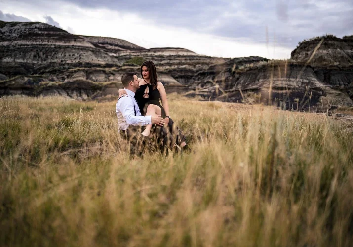 lady sits on her husbands lab during their after-wedding session with the best Calgary Wedding Photographer.