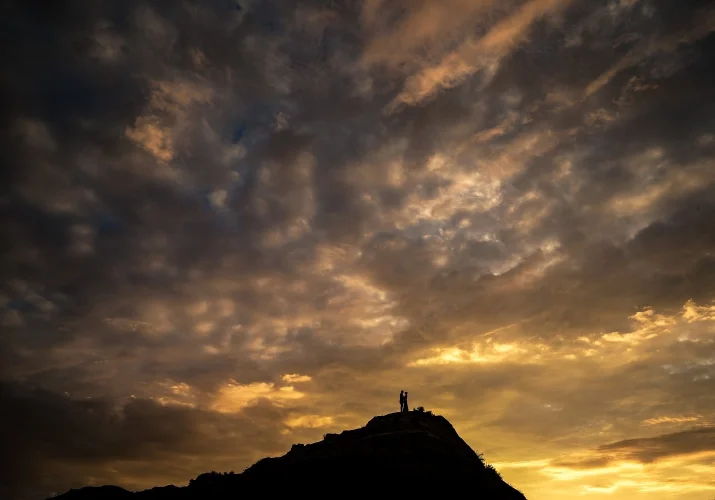 Tiny people in the frame standing in a giant Horseshoe Canyon during spectacular sunrise.