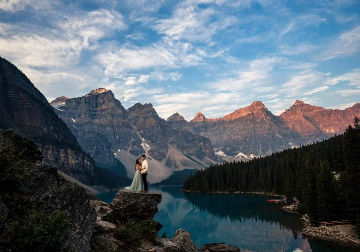 Per-wedding session of a coupe in love staying in a hug by amazing Moraine Lake in Banff.