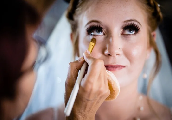 Makeup brush touches the brides face. Stunning moment from Calgary Wedding during getting ready time.