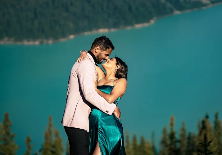 Engaged Indian couple dance in the sun and look into each others eyes.