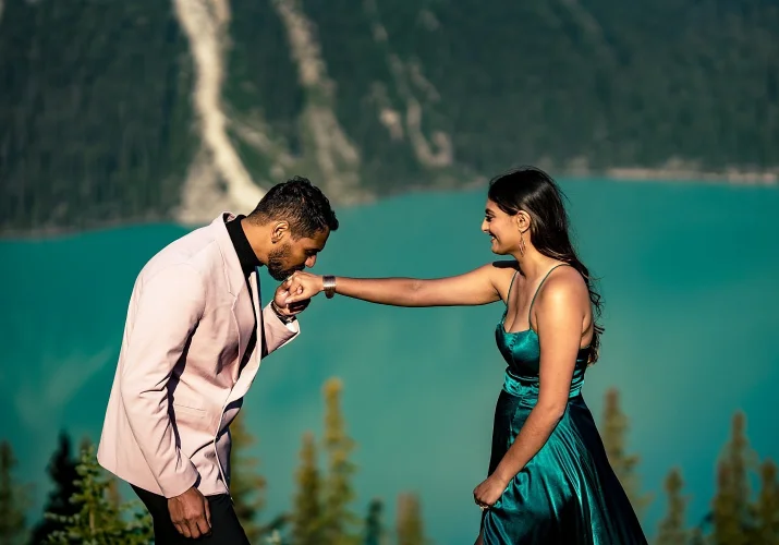Gentleman kisses his fiancees hand.