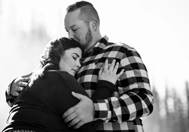 Black and white photograph of couple in a hug.