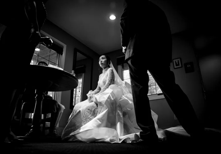 Bride sits at the chair while waiting to leave to participate in the wedding ceremony at Emerald Lake.