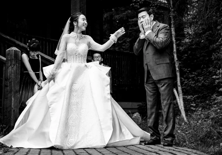 Bride's father cries before wedding while the bride tries to cheer him up.
