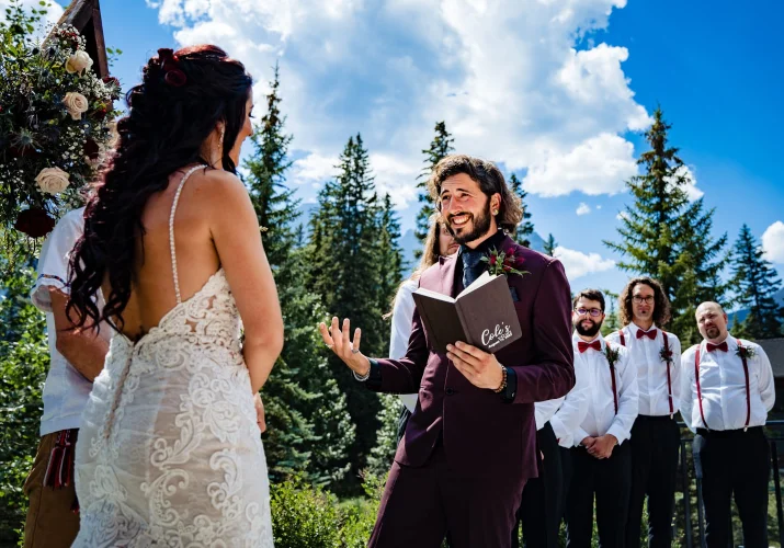 Groom gives a speech from his book at Banff Wedding Ceremony.