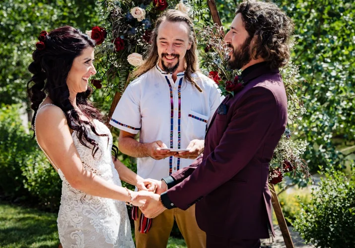 Bride and groom facing each other in front of commissioner.