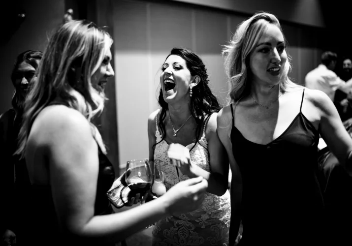 Bride laughs with her best friends.