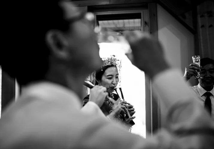 Shoot through the hand of drinking father of the bride durng Banff Wedding Reception.