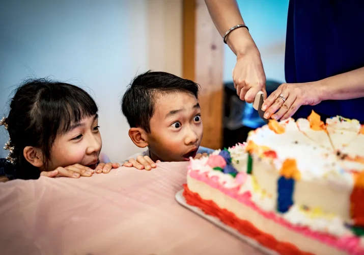 Excited kids at the wedding during cutting the cake.