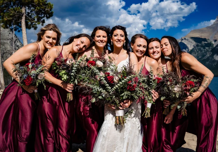 bridesmaids cuddle with the bride.