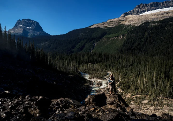 Engaged couple standing in the sun during engagement photo session with the best Banff Wedding Photographer.