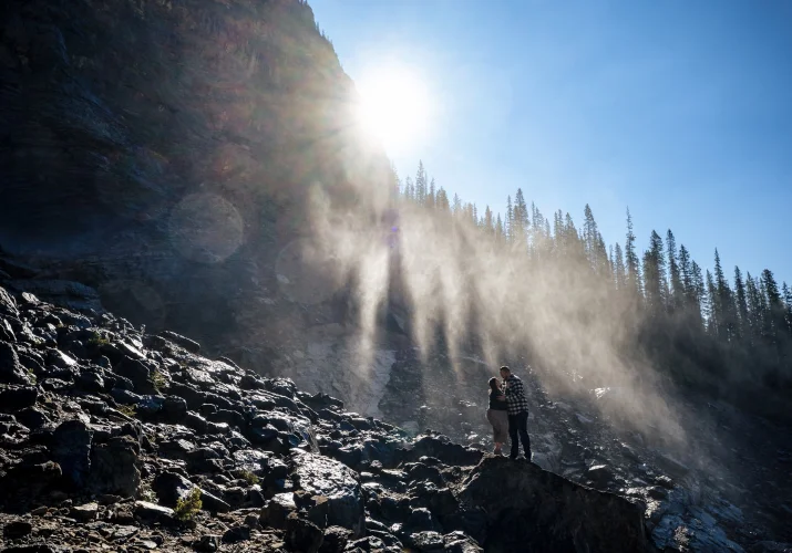 Couple in a huh at sunning waterfall in Banff.