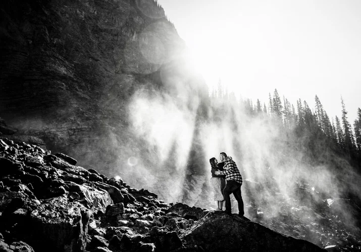 Engaged couple embraced in the sunlight during engagement session in Banff.