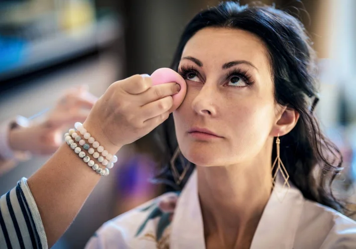 Bridesmaid getting her make up done before Calgary Wedding ceremony