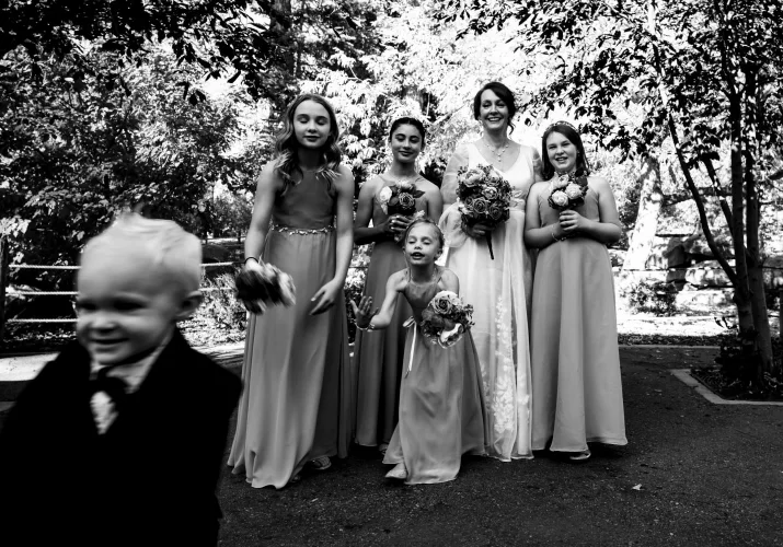 A little boy runs away fro the group photo at the Calgary wedding.