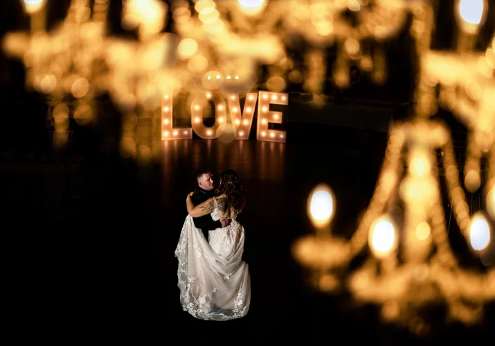 Creative Banff Wedding Photograph through chandelier. Newlyweds first dance.