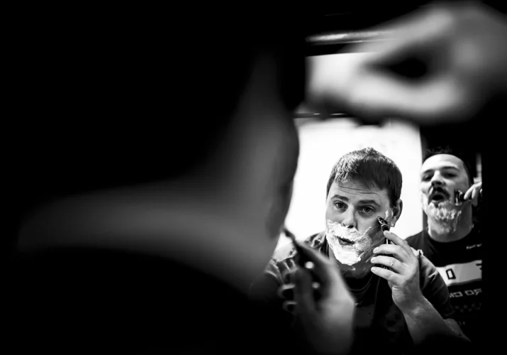 Groom and best men shave their faces at the same time. Black and white Calgary Wedding Photography.