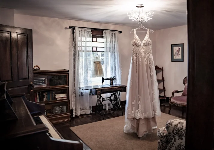 Wedding dress hanging on the chandelier in a rustic cottage. in Calgary.