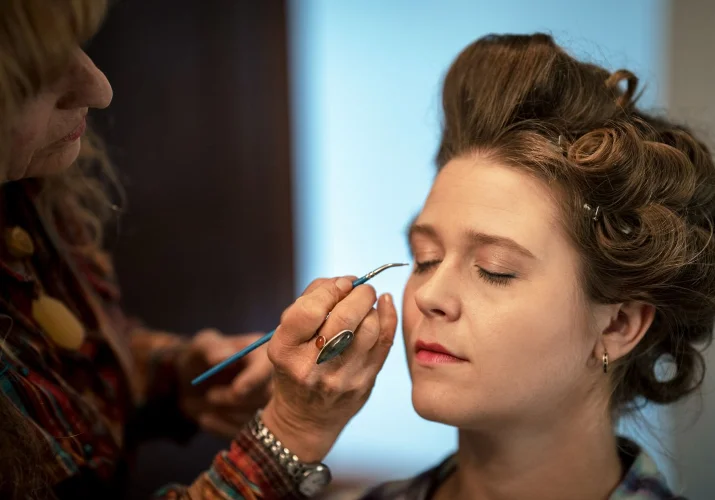 Make up artist puts up leashed in the bridesmaid eye before Calgary Wedding