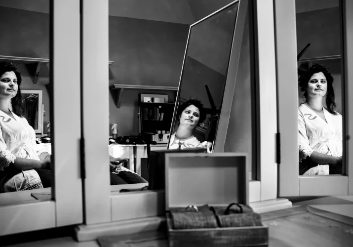 Unique photo of the bride's reflection in the mirrors taken by best Calgary Wedding Photographer.