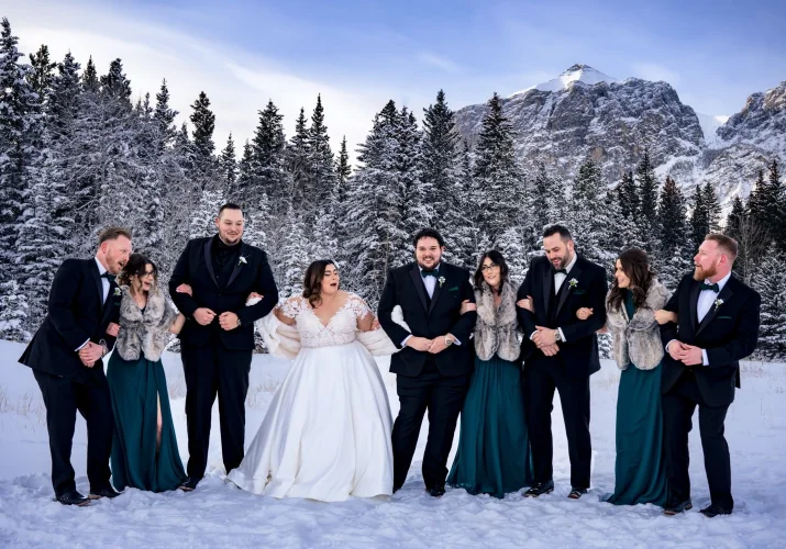 Funny and happy photography of the bridal party in Banff during wintertime.