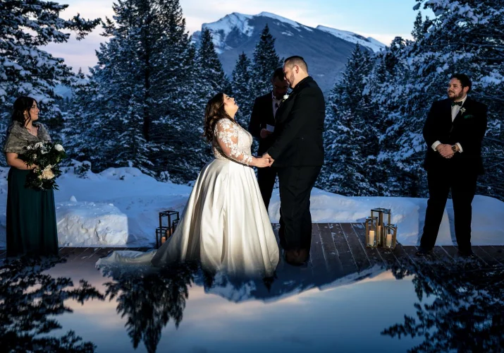 Creative photo with reflection of the sky and the mountains taken during Winter Banff Wedding Ceremony.
