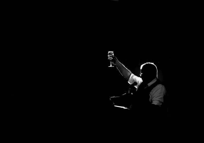 Father of the bride gives a speech with a glass of champagne in his hands.