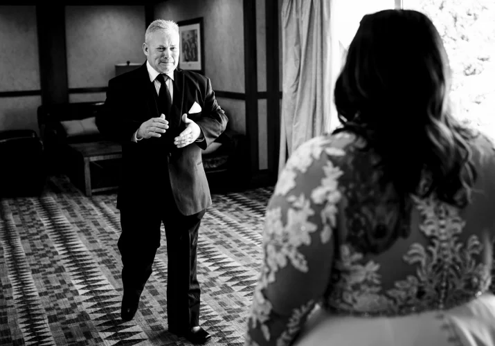 Father of the bride walks towards to hug the bride - first look - father and bride.
