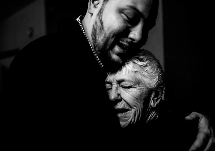 Emotional moment of the groom an his grandmother before the Banff Wedding. They are in a hug.