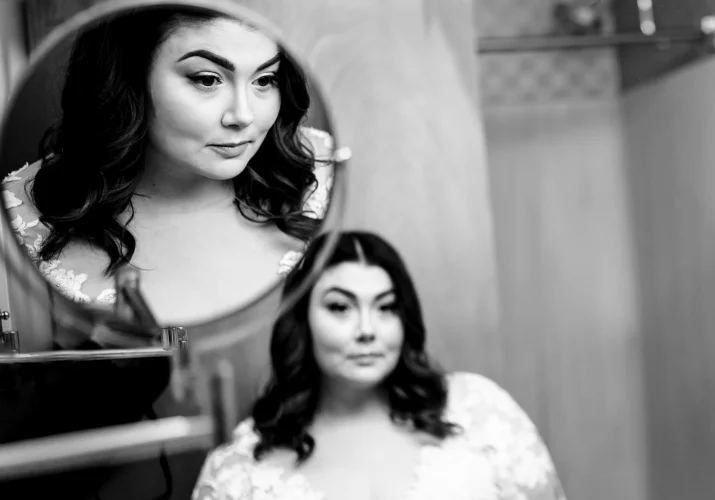 bride's reflection in two mirrors before Banff Wedding
