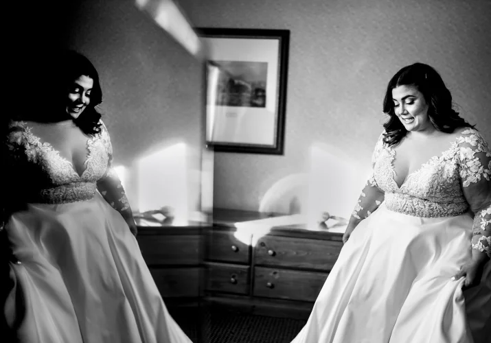 Bride look in the mirror to see herself in the wedding dress. Photograph taken by Banff Wedding Photographer.