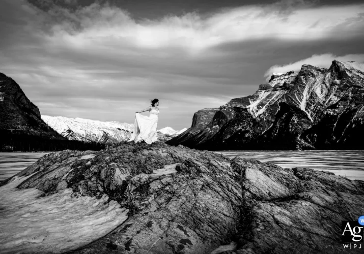 Wedding Photography in Banff of a bride at Minnewanka Lake in black and white.