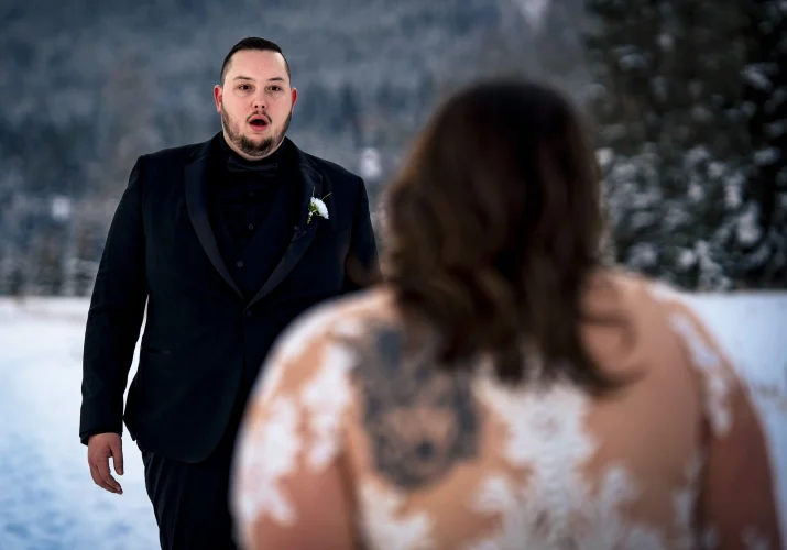 First look of bride and groom before Banff Wedding Ceremony. Groom is fascinated by beautiful bride.