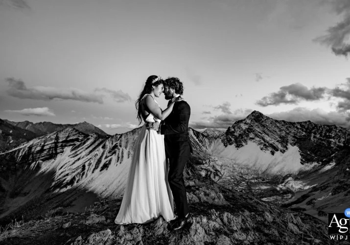 BW Banff Wedding Photography of couple on the top of the mountain looking deeply into each others eyes.